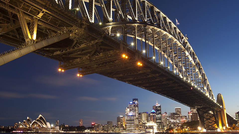 Sydney at night with the opera house in the left background