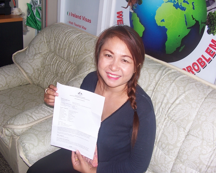 Happy client smiling with her visa to australia