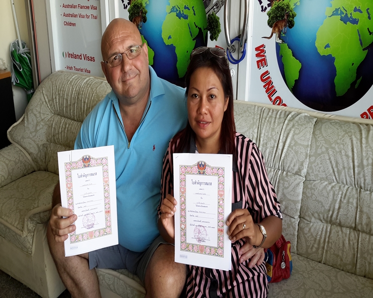 Happy clients smiling with their official documents