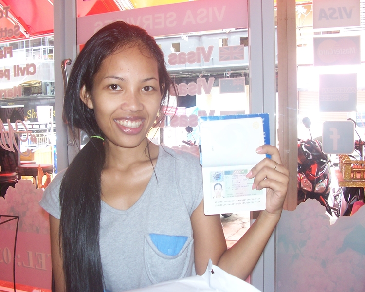 Happy Amornrat holding her visa