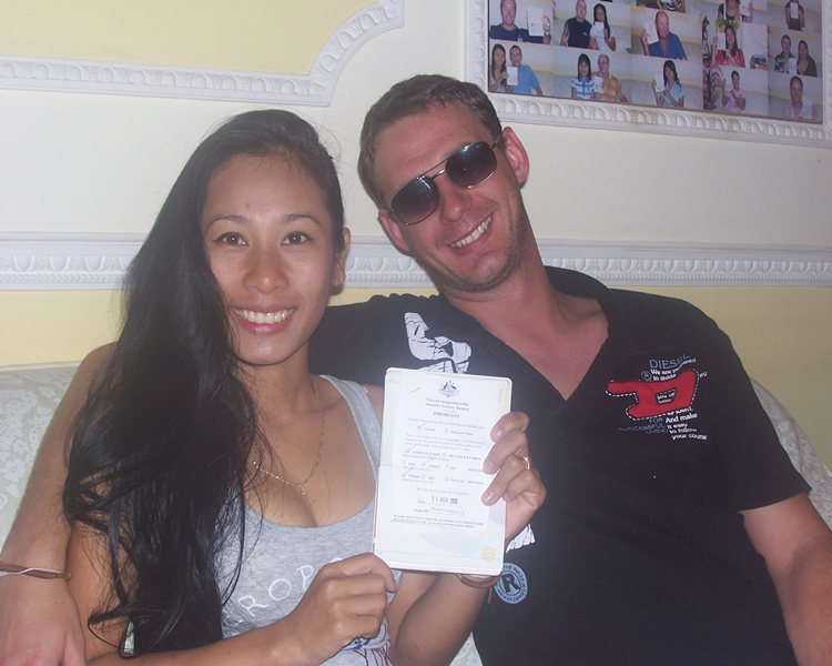 Daniel and Napapon smiling with their visa