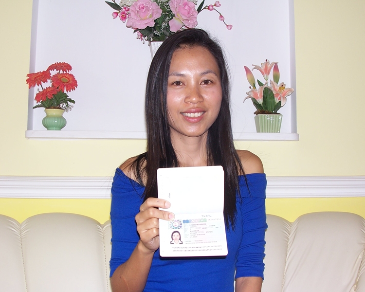 Happy client smiling with her visa
