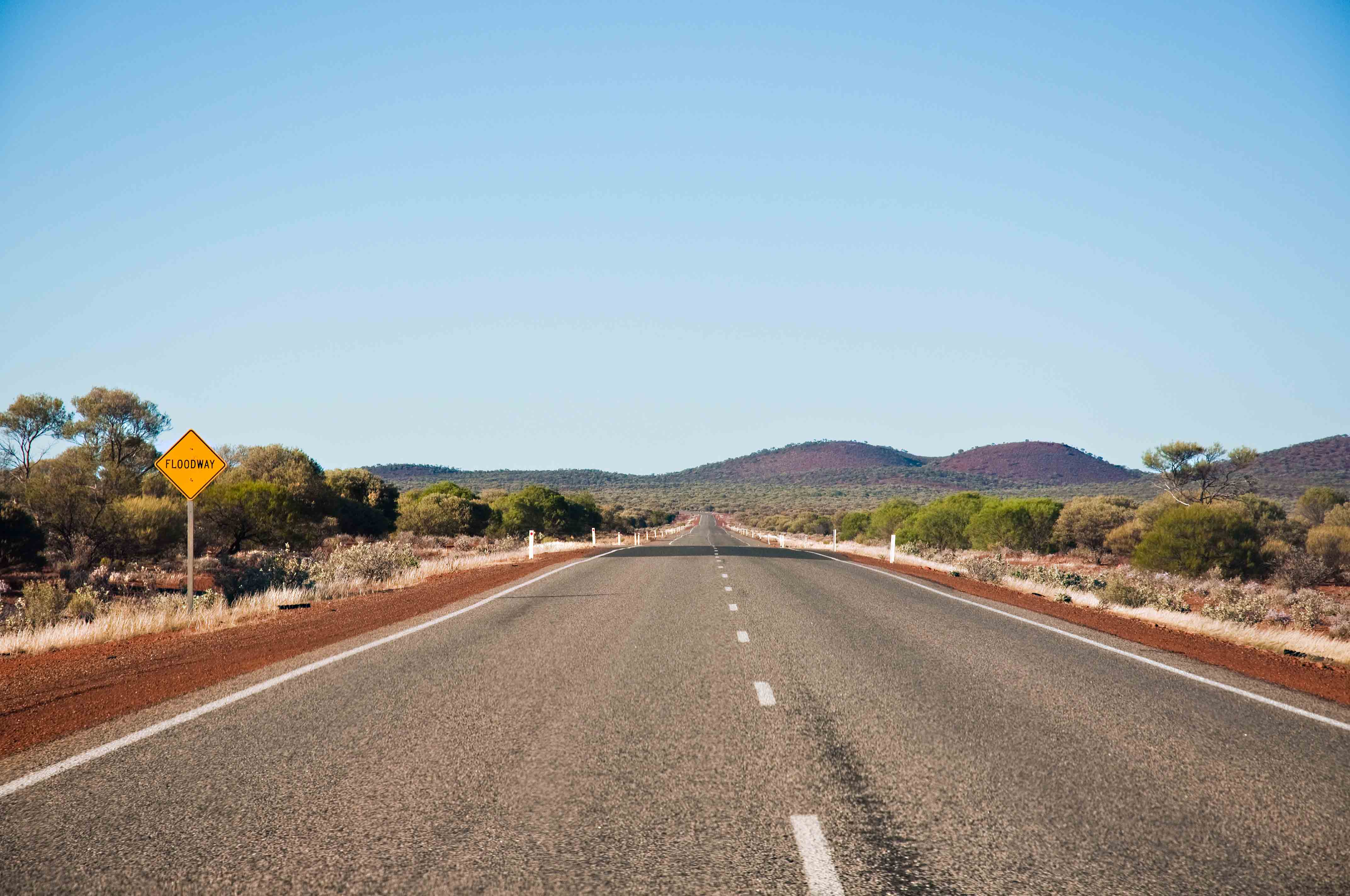 Rural Australian highway disappearing into the distance