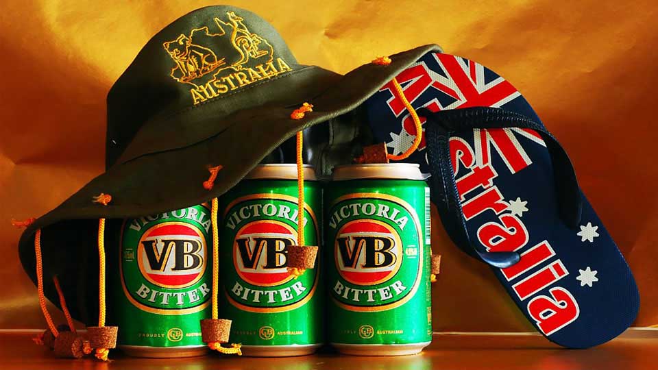 Hat with Corks Hanging From The Brim On a Six Pack of Beer and a Sandal Marked "Australia"