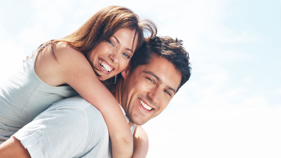 A happy couple with the woman riding piggy back