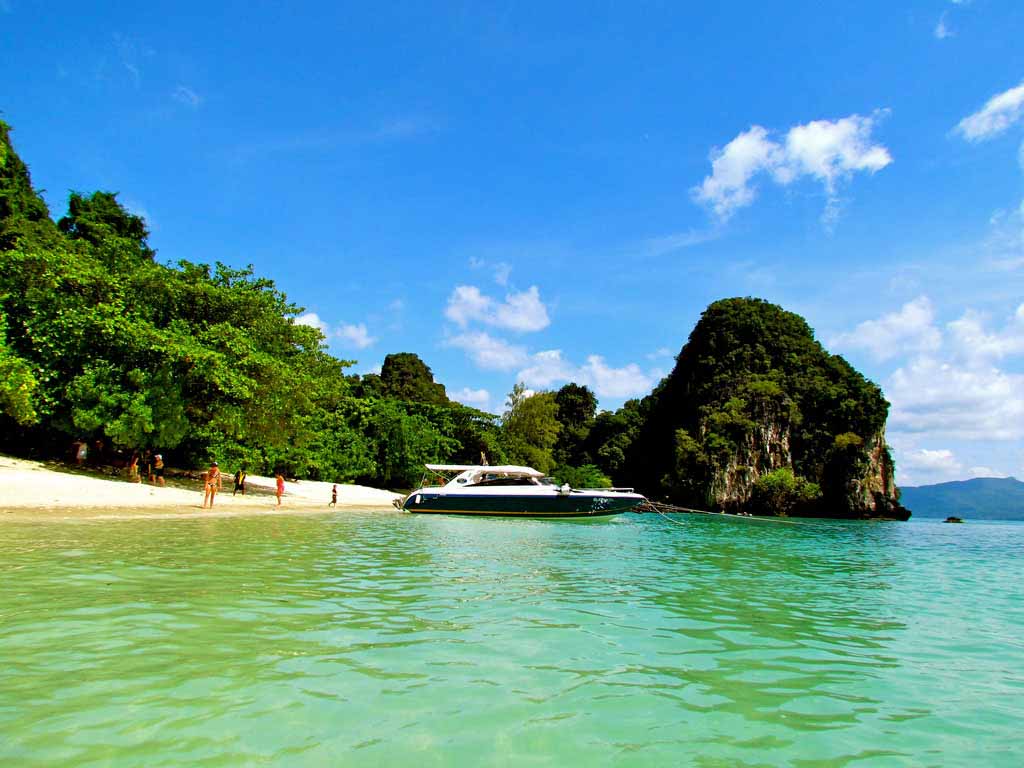 A boat anchored by a quiet beach