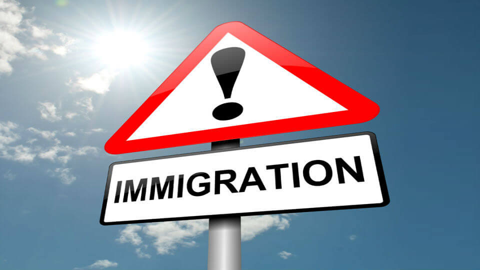 A street sign saying "Immigration"