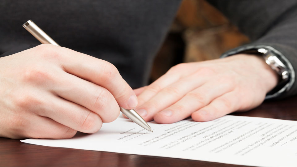 Man preparing to sign a document