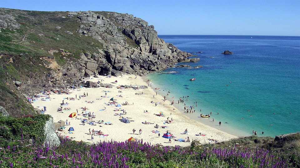 A stone cliff bordered beach