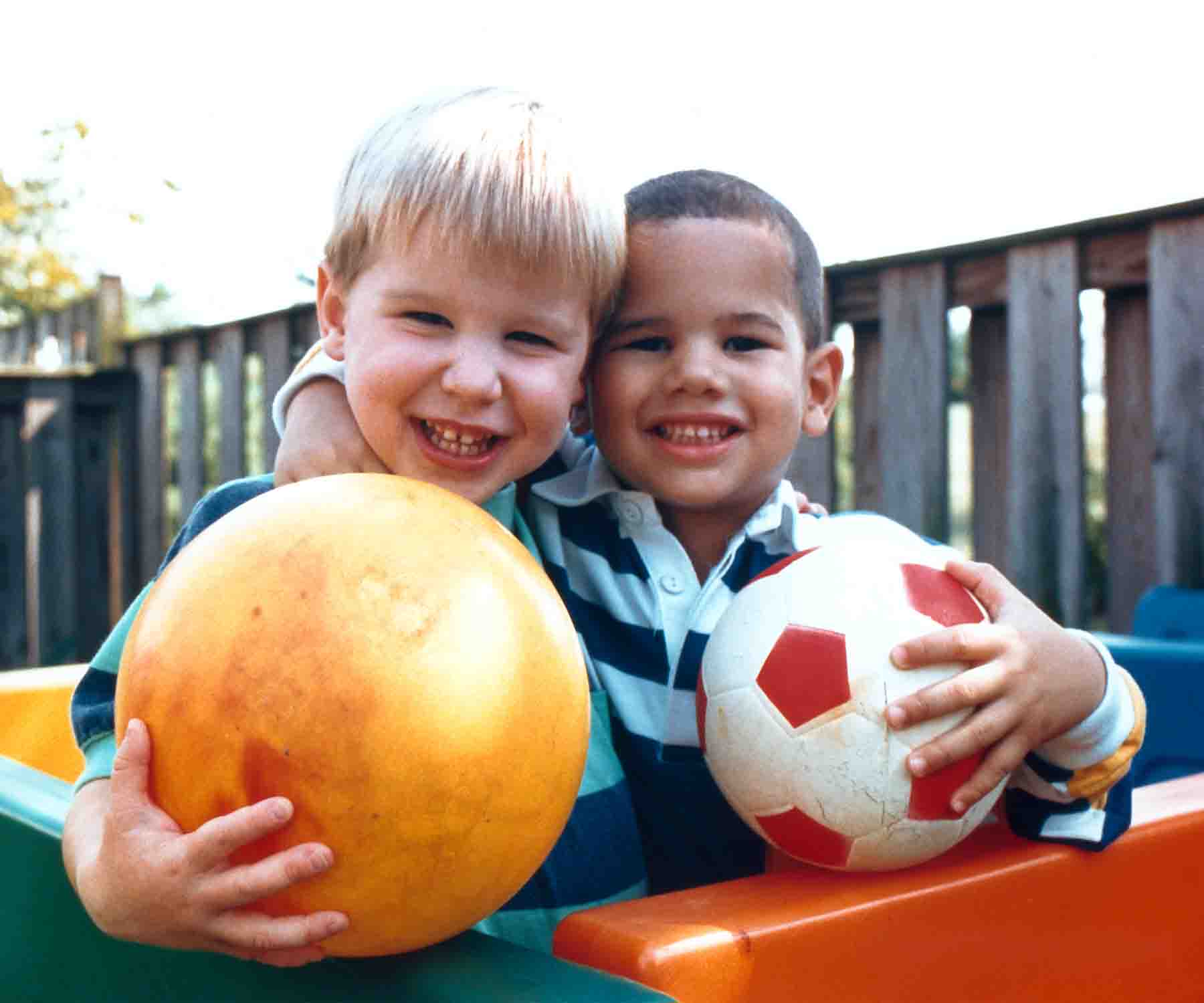 Two little boys playing with balls