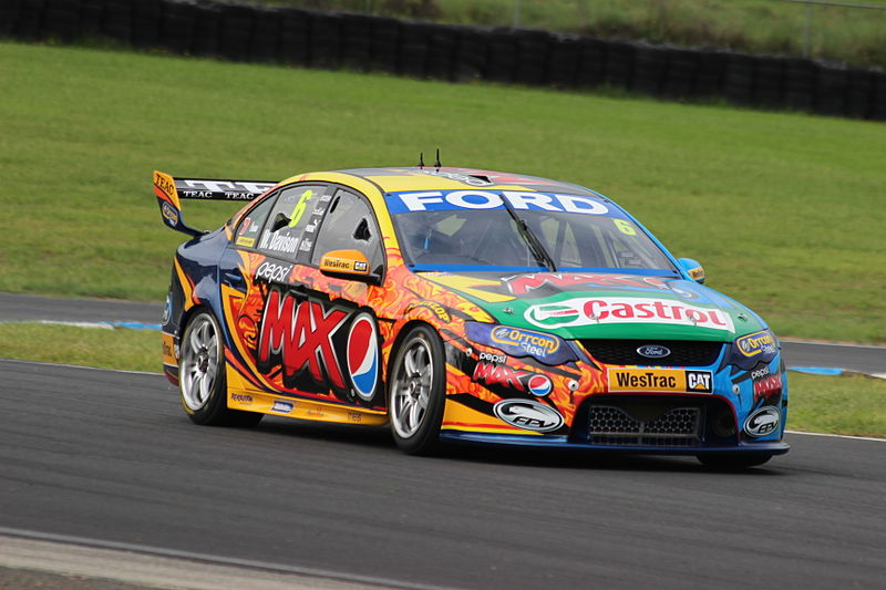 A race car with the windows broken in three places