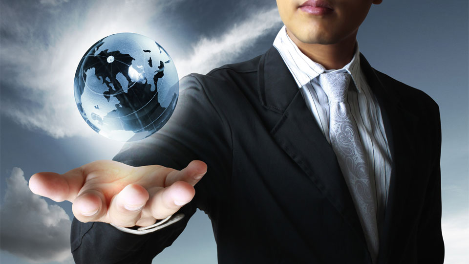 A businessman levitating a globe over his hand