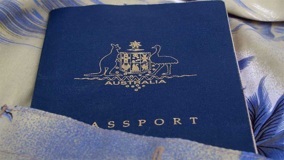 Australian passport peeking out of a shirt pocket