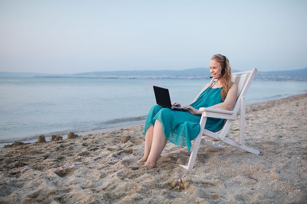 working with laptop on beach