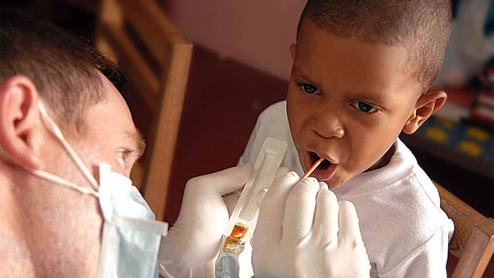 Doctor checking a young boy's mouth