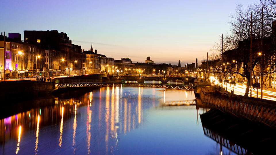 Dublin lit up for the evening, as seen from the river