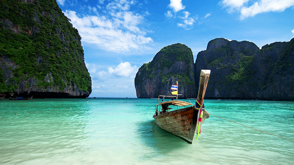 Phuket sound, boat in foreground and rocks in background