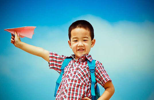 Cute Thai Boy With Paper Airplane