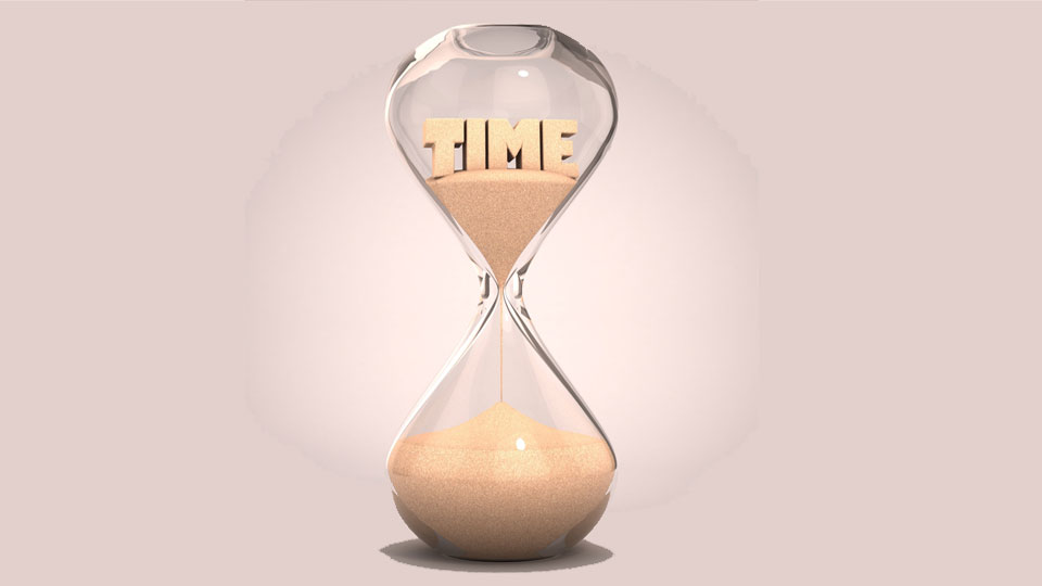 Hourglass Running with "Time" Written In Sand