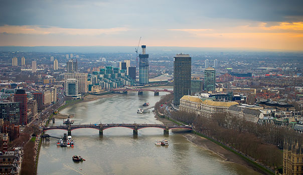 A city straddling a river at dusk or dawn