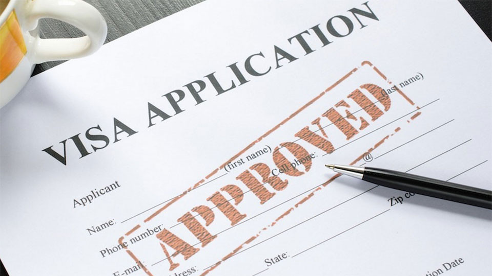 A visa application form stamped "APPROVED"